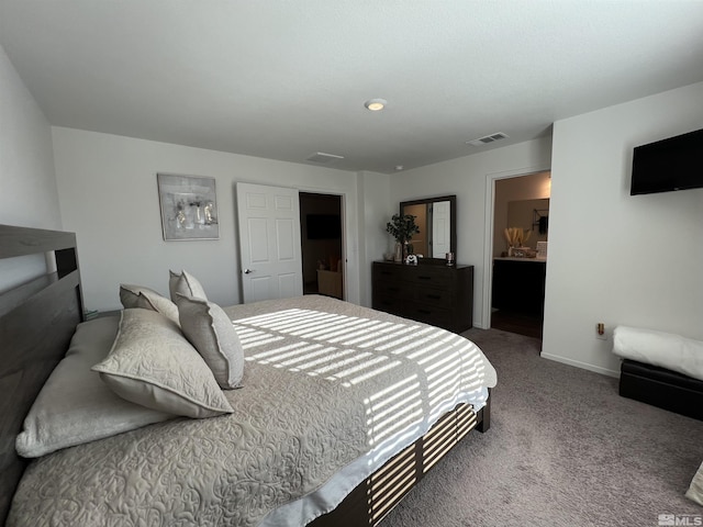 carpeted bedroom featuring ensuite bathroom