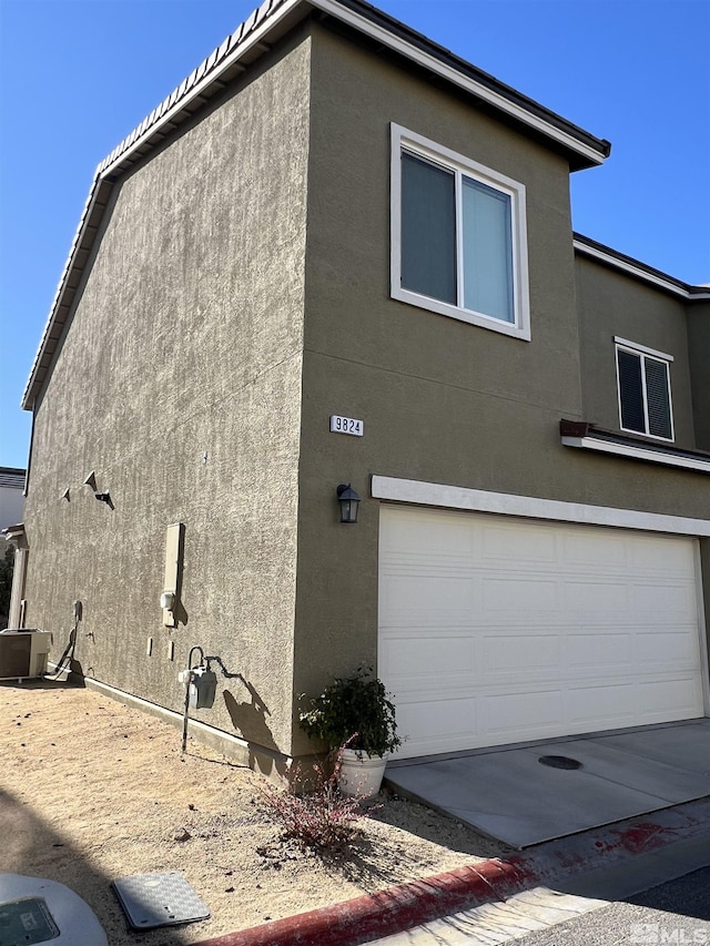 view of side of home featuring a garage