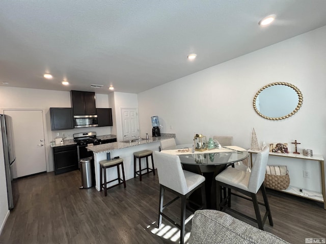 dining room featuring dark hardwood / wood-style flooring and sink