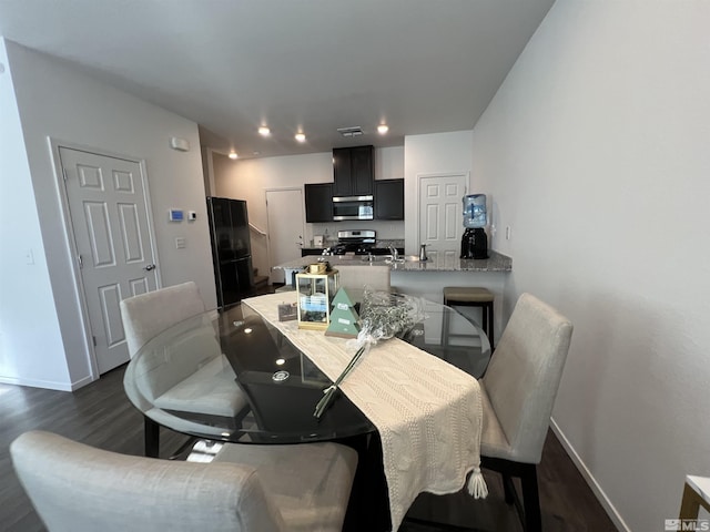 dining area with dark hardwood / wood-style flooring