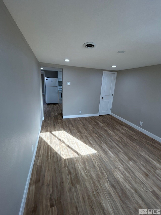 unfurnished room featuring dark wood-type flooring