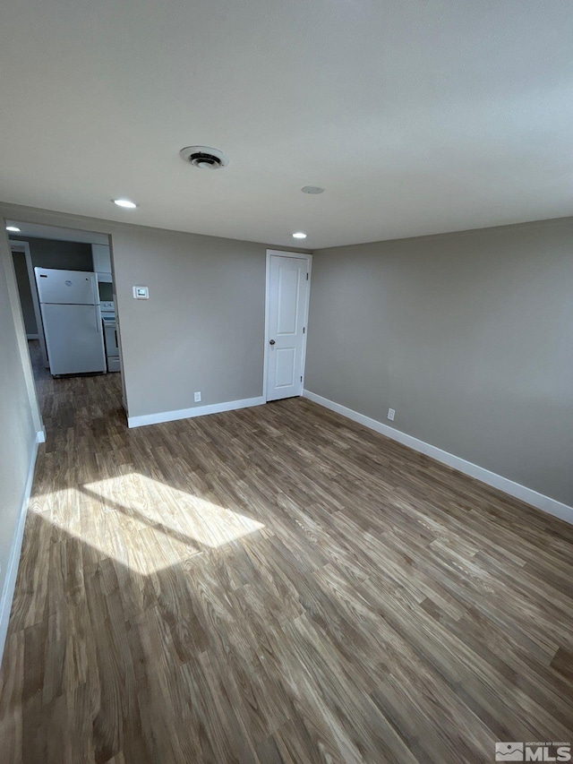 spare room featuring dark hardwood / wood-style floors