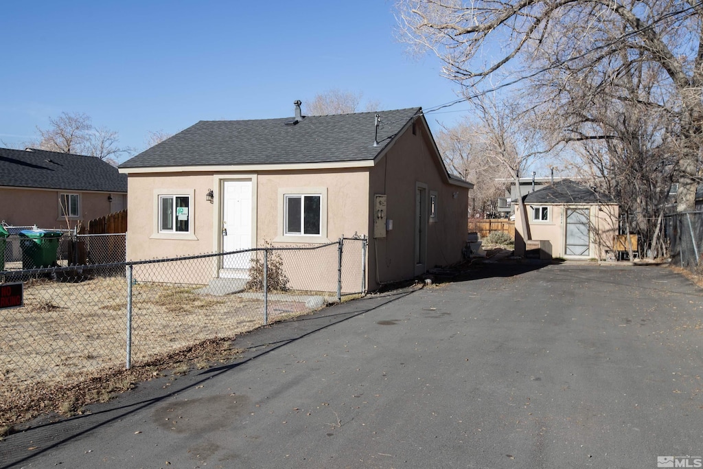 view of front of home with a shed