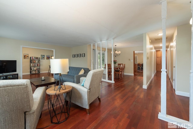 living room with dark hardwood / wood-style flooring and a chandelier