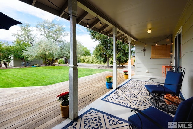 wooden deck featuring a yard