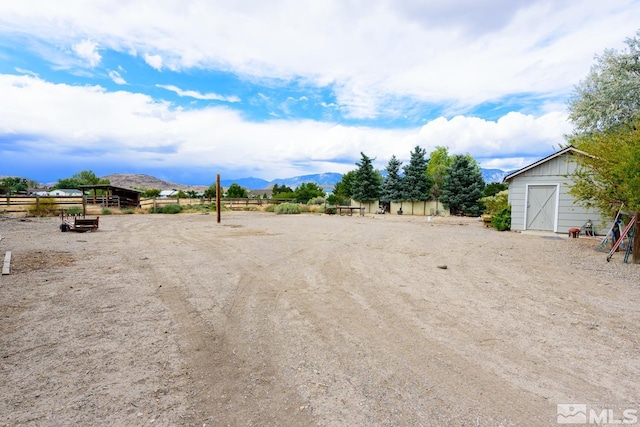 view of yard with a mountain view and an outdoor structure