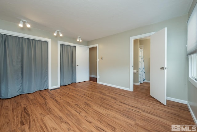 unfurnished bedroom featuring hardwood / wood-style floors