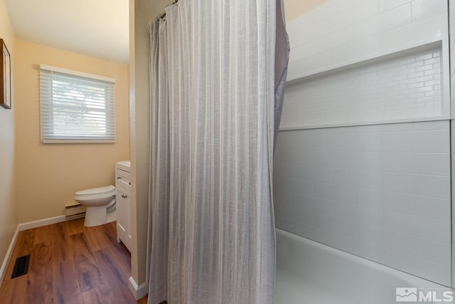 full bathroom featuring vanity, shower / bath combo with shower curtain, a baseboard heating unit, hardwood / wood-style flooring, and toilet