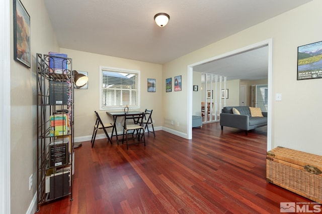 dining space with dark wood-type flooring