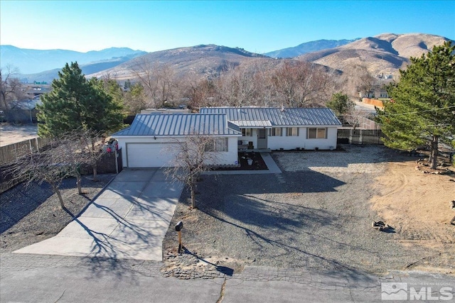 single story home featuring a mountain view and a garage