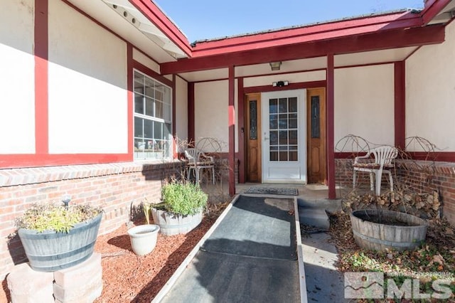 view of exterior entry with a porch