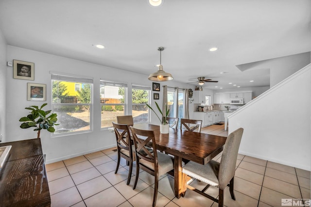 tiled dining area featuring ceiling fan