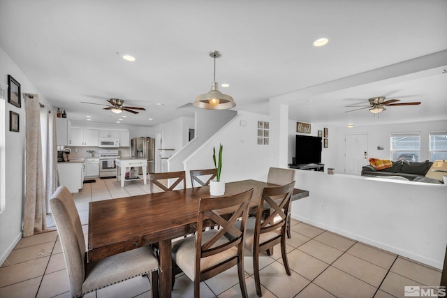 tiled dining area with ceiling fan