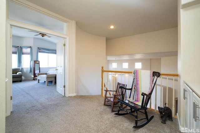 sitting room featuring light colored carpet