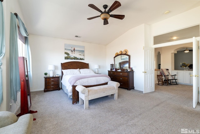 bedroom featuring ceiling fan, light colored carpet, and vaulted ceiling