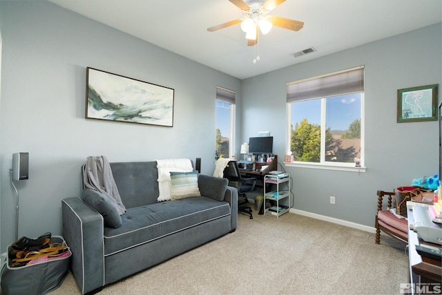 interior space featuring ceiling fan and light colored carpet