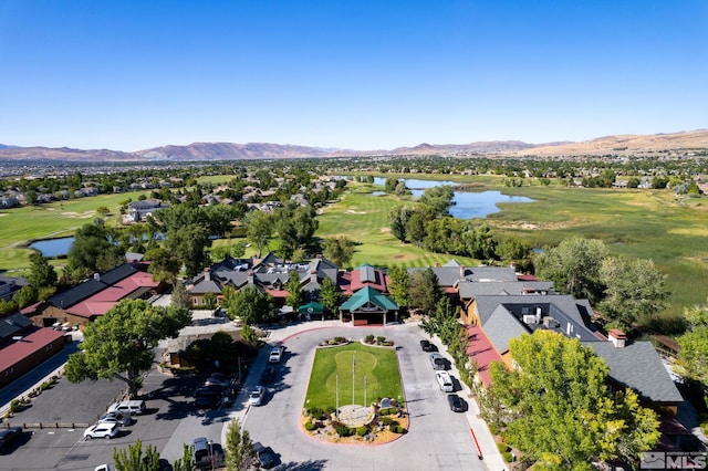 birds eye view of property with a water and mountain view