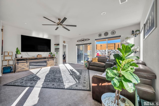 living room featuring carpet floors and ceiling fan