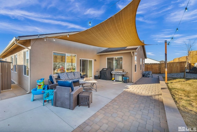 rear view of property with an outdoor living space and a patio