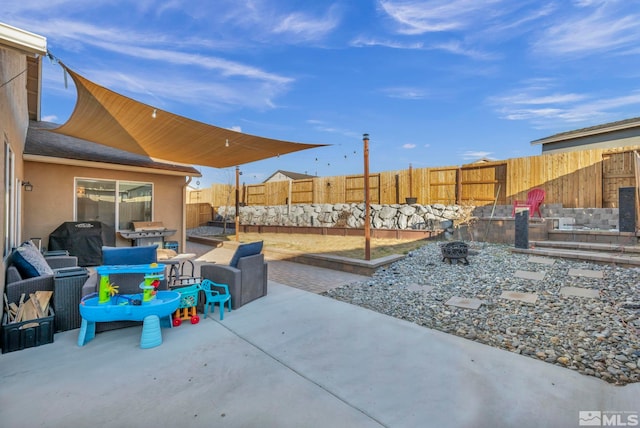 view of patio / terrace with grilling area and an outdoor living space with a fire pit