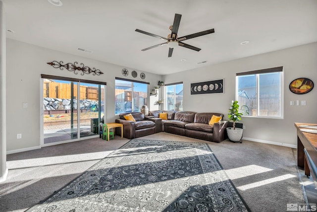 carpeted living room with ceiling fan