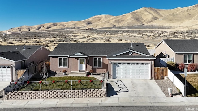 single story home featuring a mountain view and a garage