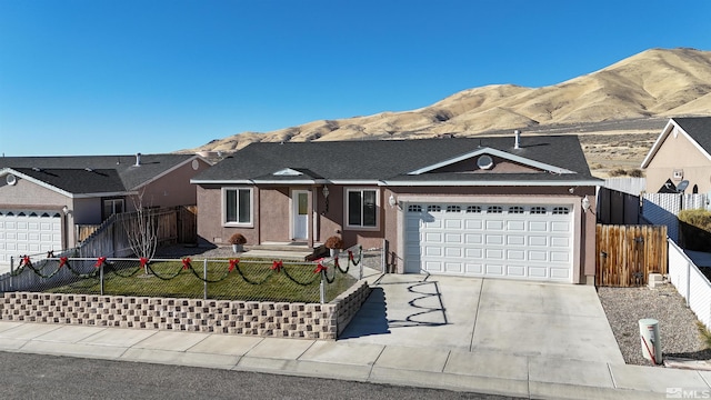 ranch-style home with a mountain view and a garage