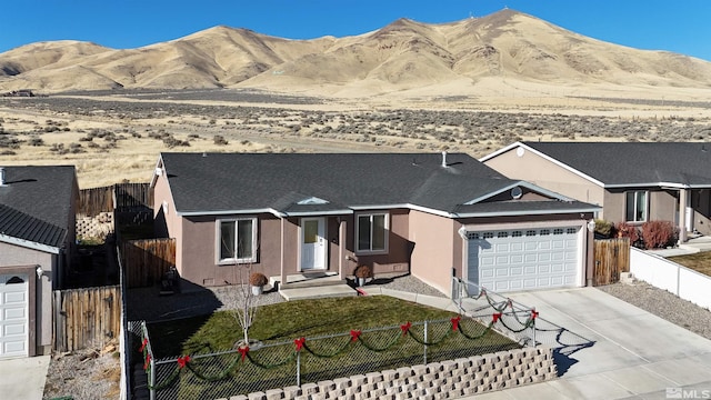 ranch-style home with a mountain view and a garage