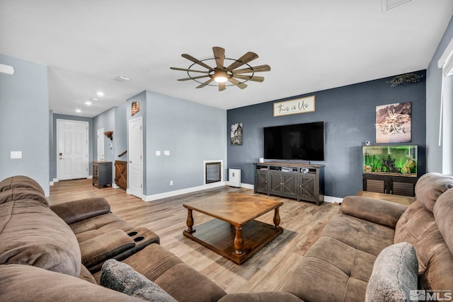 living room with light wood-type flooring and ceiling fan