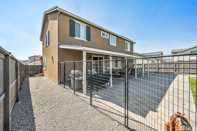 back of property with an outbuilding