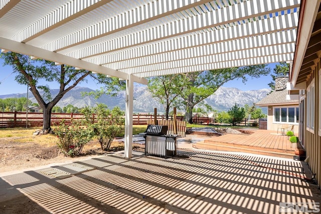 view of patio featuring a deck with mountain view and a pergola