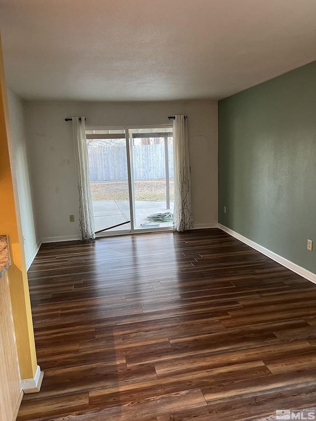 empty room with dark hardwood / wood-style floors