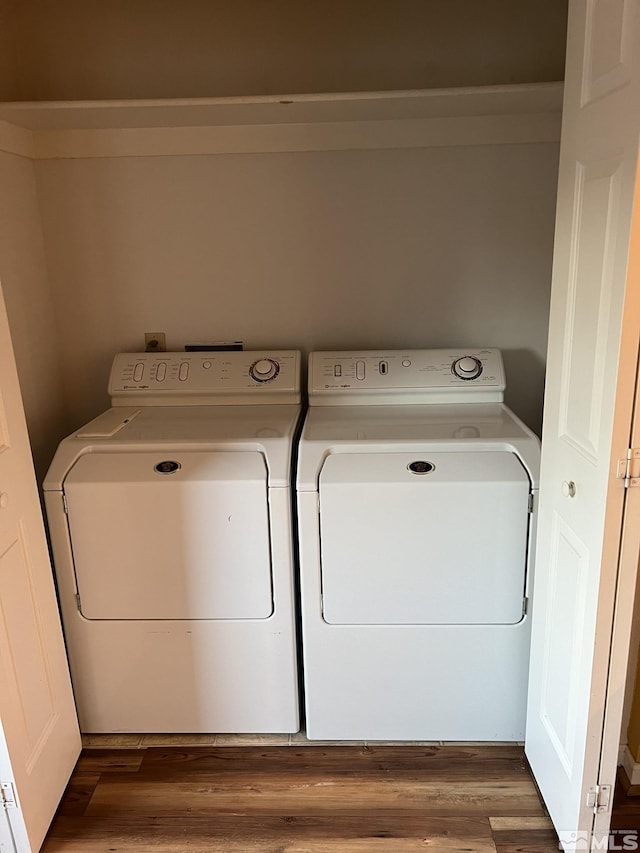 washroom with independent washer and dryer and dark hardwood / wood-style flooring