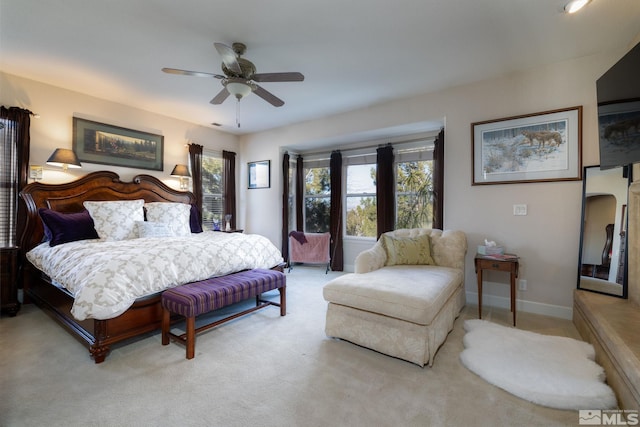 carpeted bedroom with multiple windows and ceiling fan