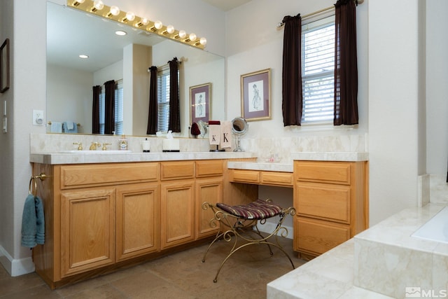 bathroom featuring tile patterned floors, vanity, and a tub to relax in