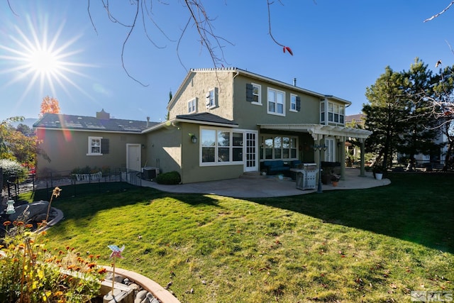 back of house featuring cooling unit, a patio area, and a lawn