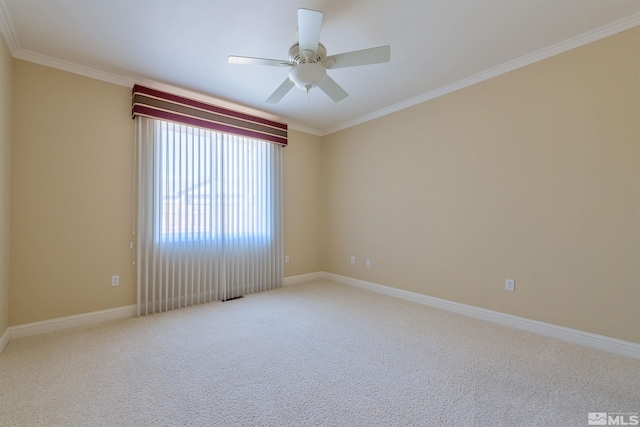 carpeted spare room featuring ceiling fan and ornamental molding