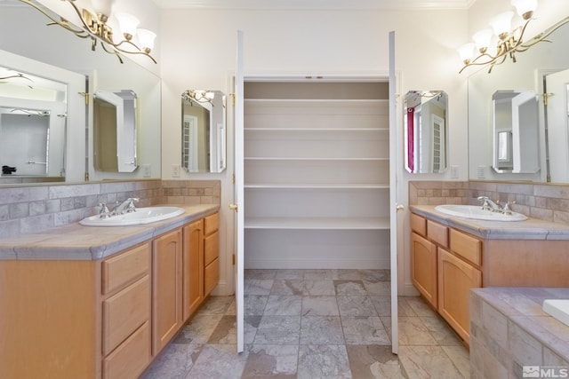 bathroom featuring vanity, tasteful backsplash, crown molding, and a notable chandelier