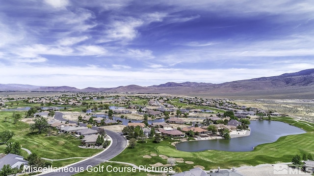 birds eye view of property featuring a water and mountain view