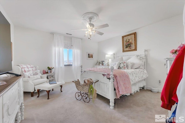 bedroom with light carpet and ceiling fan