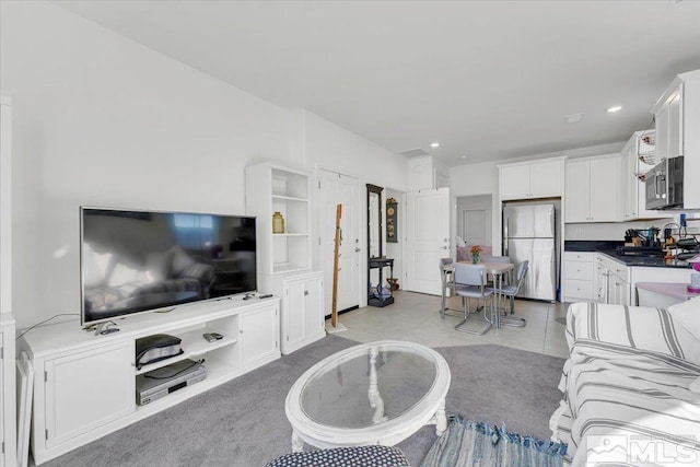 tiled living room featuring sink