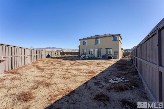 back of house featuring a mountain view