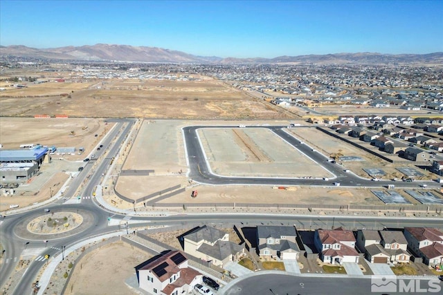 birds eye view of property featuring a mountain view