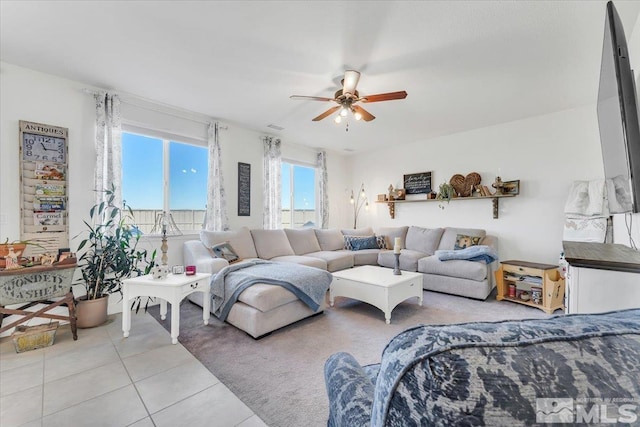 living room with light tile patterned floors and ceiling fan