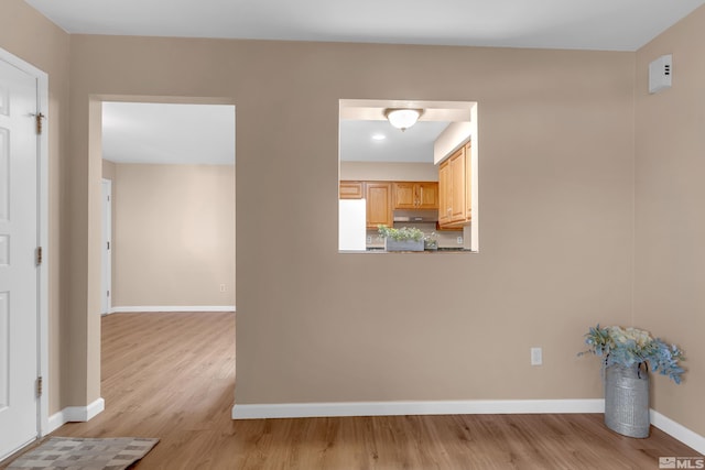 unfurnished room with light wood-type flooring