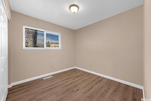 empty room with hardwood / wood-style floors