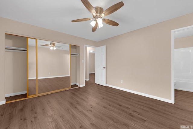 unfurnished bedroom with a closet, dark hardwood / wood-style floors, and ceiling fan