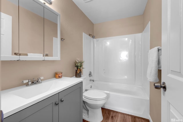 full bathroom featuring hardwood / wood-style floors, vanity, toilet, and  shower combination