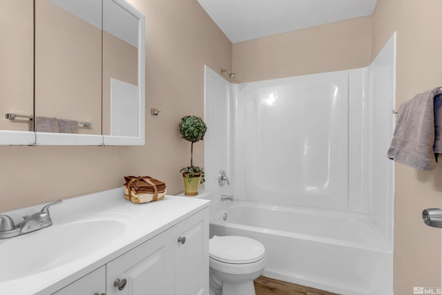 full bathroom with vanity, toilet, wood-type flooring, and tub / shower combination