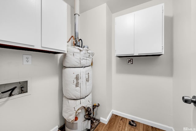 laundry area with cabinets, washer hookup, and hardwood / wood-style flooring